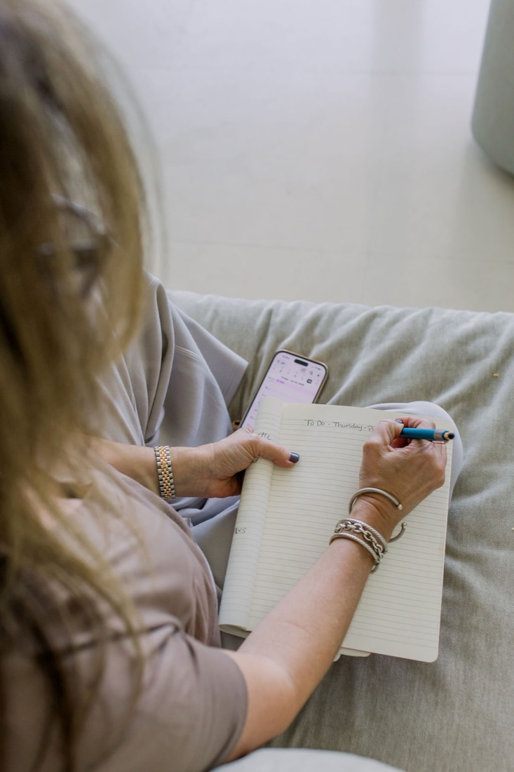 Close crop of Carrie writing in a journal